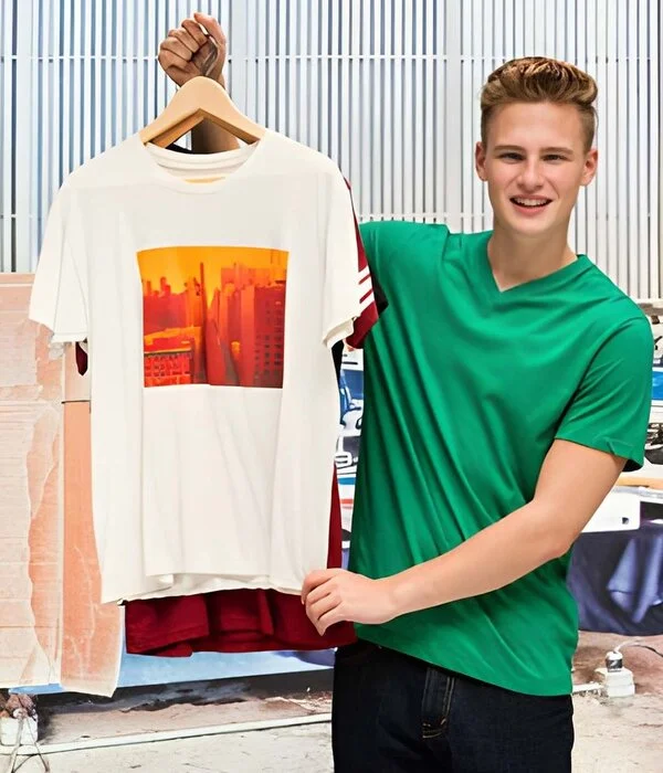 team members at humex apparel examining a custom white t shirt in their creative workspace