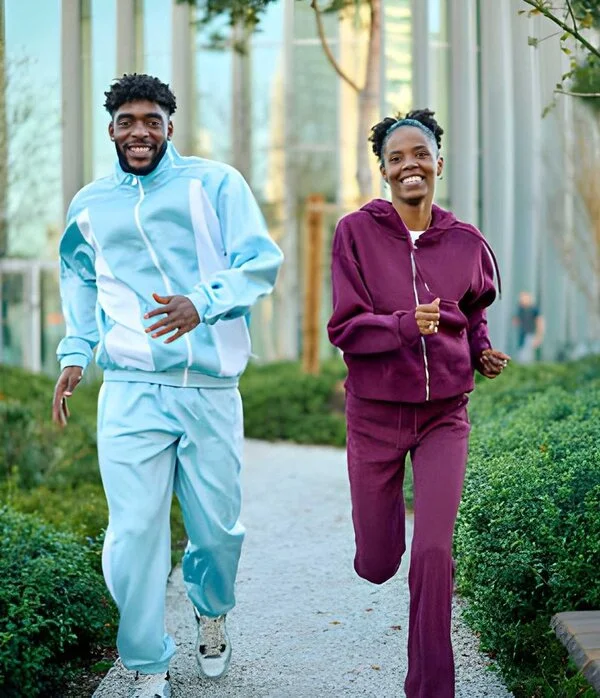 Couple wearing colorful custom tracksuit designed by Humex Apparel