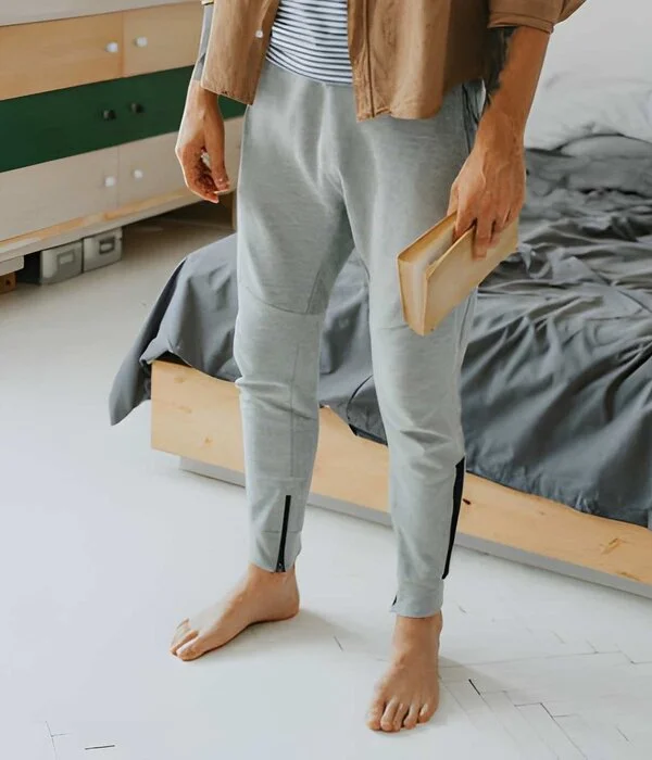 male wearing grey color sweatpants standing in garden designed by sweatpants manufacturers in usa